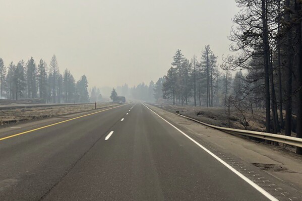 This photo provided by WSDOT East (Washington State of Transportation) smoke from wildfires fill the sky at Salnave/SR 902 interchange in Spokane County, Wash., on Saturday, Aug. 19, 2023. A fast-moving wildfire in eastern Washington state has destroyed at least 185 structures, closed a major highway and left one person dead. The blaze started on the west side of Medical Lake, a town west of Spokane, at about 12:30 p.m. Friday. (WSDOT East via AP)