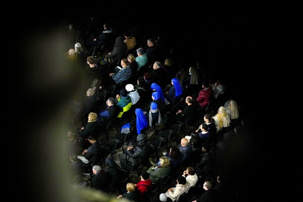People attend a rosary prayer with Cardinal Victor Manuel Fernandez held for the health of Pope Francis in St Peter's Square at the Vatican, Friday, Feb. 28, 2025. (AP Photo/Andrew Medichini)