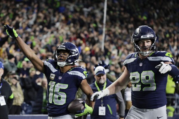Seattle Seahawks wide receiver Tyler Lockett (16) celebrates a touchdown in the second half of an NFL football game against the Washington Commanders in Seattle, Sunday, Nov. 12, 2023. (AP Photo/John Froschauer)