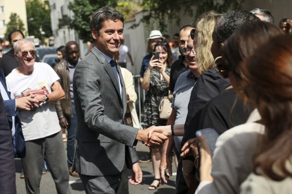 French Prime Minister Gabriel Attal arrives to vote for the first round of parliamentary elections in Vanves, outside Paris, Sunday, June 30, 2024. (AP Photo/Thomas Padilla)