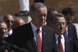 Turkey's President Recep Tayyip Erdogan and other officials walk to the mausoleum of modern Turkey's founder Mustafa Kemal Ataturk on Victory Day, in Ankara, Turkey, Tuesday, Aug. 30, 2022. Turkey is celebrating August 30 Victory Day, which marks the Turkish victory against Greek forces at the Battle of Dumlupinar, the crucial battle of the War of Independence in 1922 that led subsequently to the foundation of modern Turkish republic. (AP Photos/Burhan Ozbilici)