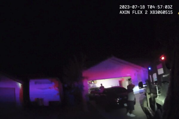In this Monday evening, July 17, 2023 image taken from police body camera video provided by the Las Vegas Metropolitan Police Department, an unidentified man and woman are seen as SWAT officers raided a home in the nearby city of Henderson, Nev., in connection with the 1997 killing of rapper Tupac Shakur near the Las Vegas Strip. (Las Vegas Metropolitan Police Department via AP)