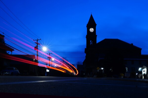 Pre-dawn traffic travels past Town Hall in Hinsdale, N.H., Thursday, Nov. 16, 2023. The small town received a generous gift when a longtime resident passed away in June. (AP Photo/Robert F. Bukaty)