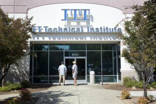 FILE - In this Sept. 6, 2016, file photo, Harold Poling, left, and Ted Weisenberger check the doors to the ITT Technical Institute after ITT Educational Services announced that the school had ceased operating in Rancho Cordova, Calif. The U.S. Education Department has not approved any applications for student-loan forgiveness in cases of possible fraud since President Donald Trump took office, according to records sent to an Illinois senator. The records also revealed that the department has continued to receive new applications from borrowers who say they were victims of fraud, mostly from Corinthian borrowers and from former students of ITT Technical Institute. (AP Photo/Rich Pedroncelli, File)