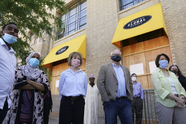 Minnesota Gov. Tim Walz, Sen. Amy Klobuchar, right, and Sen. Tina Smith, third from right, meet with business owners that were affected by events following the George Floyd protests Friday, June 5, 2020 at Hawthorne Crossings in north Minneapolis. Floyd died after being restrained by Minneapolis police officers on May 25. (Anthony Souffle/Star Tribune via AP)