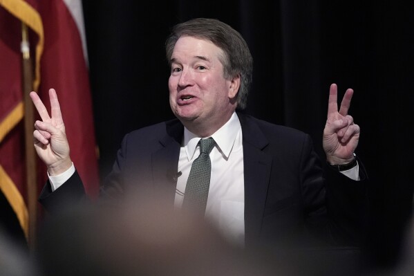 Supreme Court Justice Brett Kavanaugh makes air quotes as he answers questions during a judicial conference, Friday, May 10, 2024, in Austin, Texas. (AP Photo/Eric Gay)