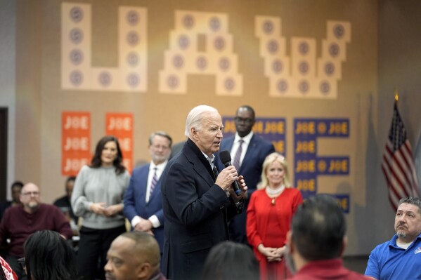 President Joe Biden addresses UAW members during a campaign stop at a phone bank in the UAW Region 1 Union Hall, Thursday, Feb. 1, 2024, in Warren, Mich. Looking on in background are Michigan Gov. Gretchen Whitmer, Sen. Gary Peters, D-Mich., Michigan Lieutenant Governor Garlin Gilchrist and Rep. Debbie Dingell, D-Mich. (AP Photo/Evan Vucci)