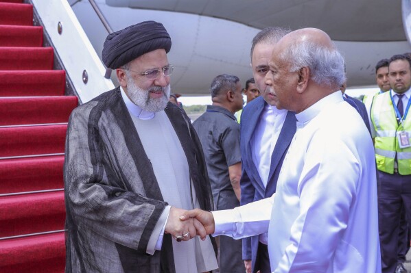 Iranian President Ebrahim Raisi, left is received by Sri Lankan Prime Minister Dinesh Gunawardena as he arrives at the Mattala International airport in Mattala, Sri Lanka, Wednesday, April 24, 2024. (Sri Lanka President's Office via AP)