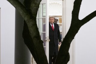 President Donald Trump walks out of the Oval Office to board Marine One on the South Lawn of the White House in Washington, Monday, Jan. 4, 2021, for a short trip to Andrews Air Force Base, Md., and then on to Dalton, Ga. for a rally. (AP Photo/Andrew Harnik)