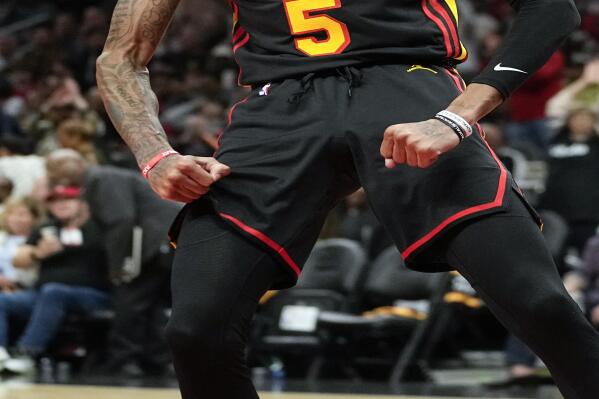 Atlanta Hawks guard Dejounte Murray (5) reacts after a basket Cleveland Cavaliers during the first half of an NBA basketball game Friday, Feb. 24, 2023, in Atlanta. (AP Photo/John Bazemore)