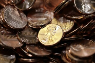 Freshly-made pennies sit in a bin at the U.S. Mint in Denver on Aug. 15, 2007. (AP Photo/David Zalubowski, File)