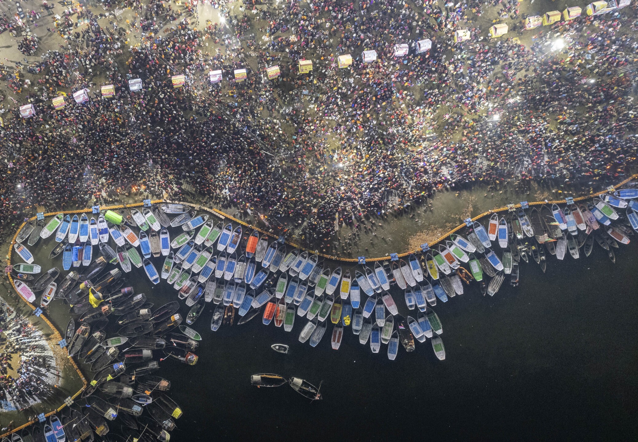 Hindu devotees crowd the Sangam, the confluence of the rivers Ganges, Yamuna and the mythical Saraswati, to take a holy dip on Mauni Amavsya or the new moon day, the most auspicious day during the annual month-long Hindu religious fair "Magh Mela" in Prayagraj, India, on Jan. 21, 2023. (AP Photo/Satya Prakash)