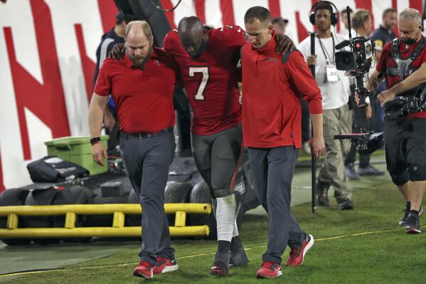 Tampa Bay Buccaneers running back Leonard Fournette (7) is helped off the field after getting hurt against the New Orleans Saints during the second half of an NFL football game Sunday, Dec. 19, 2021, in Tampa, Fla. (AP Photo/Mark LoMoglio)