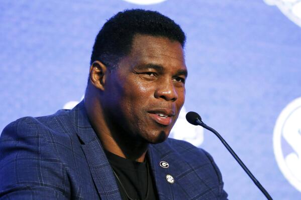 FILE - In this July 16, 2019, file photo, Herschel Walker talks about 150 years of college football during the NCAA college football Southeastern Conference Media Day in Hoover, Ala. Walker appears to have a coveted political profile for a potential Senate candidate in Georgia. (AP Photo/Butch Dill, File)