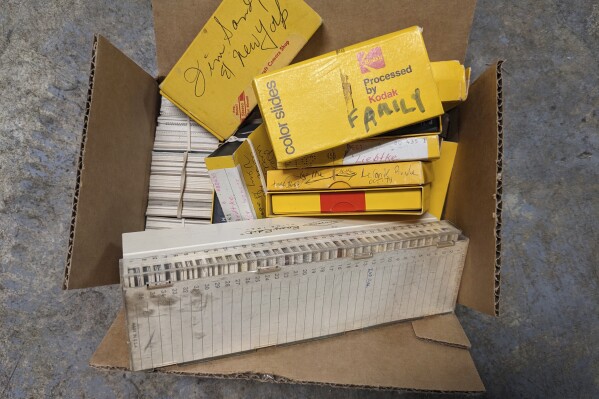 This August 2023 photo shows one of the boxes of photographic slides that AP Technology Writer Michael Liedtke inherited from his father, James. Old photos can be a treasure that keeps on giving — if you can get them out of boxes and drawers and get at them. That's where digitization comes in. (AP Photo/Michael Liedtke)