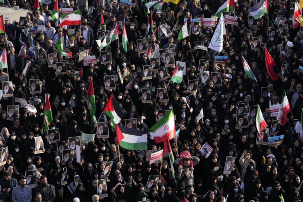 Iranian protestors attend an anti-Israel rally as they hold up posters of the Supreme Leader Ayatollah Ali Khamenei and Iranian and Palestinian flags, at Enqelab-e-Eslami (Islamic Revolution) Square in Tehran, Iran, Wednesday, Oct. 18, 2023. (AP Photo/Vahid Salemi)