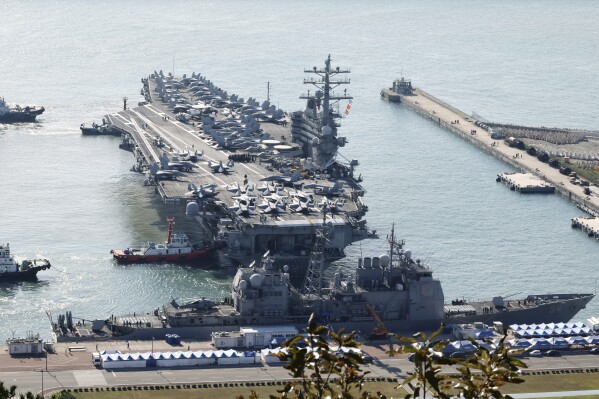 U.S. nuclear-powered aircraft carrier USS Ronald Reagan is escorted as it arrives in Busan, South Korea, Thursday, Oct. 12, 2023. (Kang Duck-chul/Yonhap via AP)