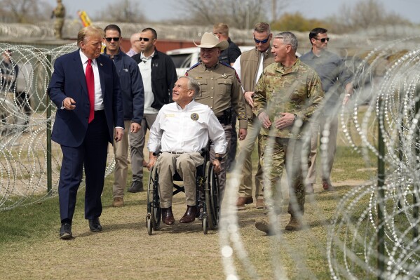 Republican presidential candidate former President Donald Trump talks with Texas Gov. Greg Abbott during a visit to the U.S.-Mexico border, Thursday, Feb. 29, 2024, in Eagle Pass, Texas. (AP Photo/Eric Gay)
