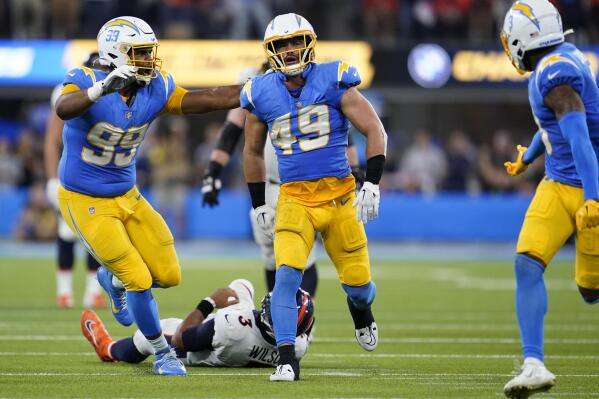 Los Angeles Chargers linebacker Drue Tranquill (49) celebrates his sack against Denver Broncos quarterback Russell Wilson during the second half of an NFL football game, Monday, Oct. 17, 2022, in Inglewood, Calif. (AP Photo/Marcio Jose Sanchez)