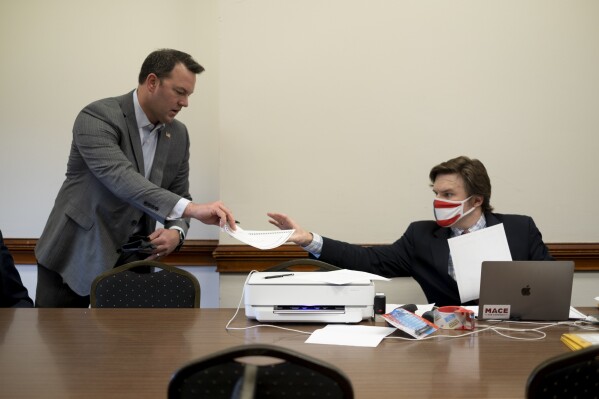 FILE - Georgia Republican Burt Jones, then a state senator and now lieutenant governor, hands in an electoral certificate claiming to be a duly chosen elector for Donald Trump on Dec. 14, 2020, at the Georgia Capitol in Atlanta. A judge on Friday, Jan. 5, 2024 tossed out a legal action arguing Jones should be disqualified from holding office in Georgia because of his actions as an elector. (AP Photo/Ben Gray, File)