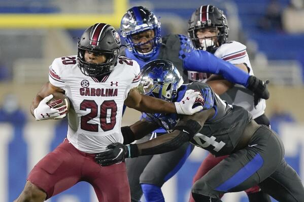 FILE- In this Dec. 5, 2020, file photo, South Carolina running back Kevin Harris (20) runs with the ball during the first half of an NCAA college football game against Kentucky in Lexington, Ky. Harris, rhe Southeastern Conference's leading rusher last year, is expected to play for the first time this season when South Carolina goes to East Carolina on Saturday.  (AP Photo/Bryan Woolston, File)