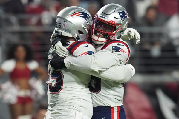New England Patriots defensive tackle Daniel Ekuale, left, celebrates a sack against the Arizona Cardinals with safety Kyle Dugger during the second half of an NFL football game, Monday, Dec. 12, 2022, in Glendale, Ariz. (AP Photo/Ross D. Franklin)