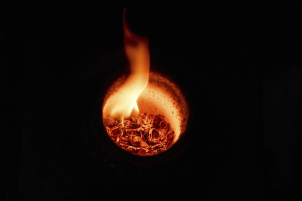 Gold jewelry melts inside a crucible at A&M Precious Metals in the St. Vincent Jewelry Center in the Jewelry District of Los Angeles, Friday, May 2, 2025. (AP Photo/Jae C. Hong)