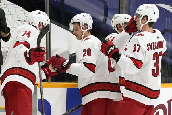 Carolina Hurricanes center Sebastian Aho (20) is congratulated as he leaves the ice after an NHL hockey game against the Nashville Predators Tuesday, March 2, 2021, in Nashville, Tenn. Aho scored twice as the Hurricanes won 4-2. (AP Photo/Mark Humphrey)