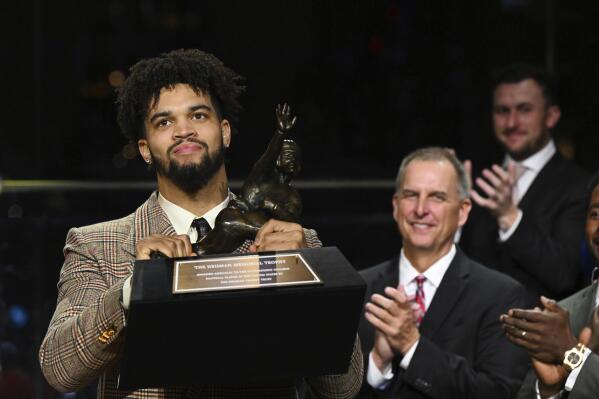 Southern California quarterback Caleb Williams holds the Heisman Trophy after winning the award Saturday, Dec. 10, 2022, in New York. (Todd Van Emst/Pool Photo via AP)