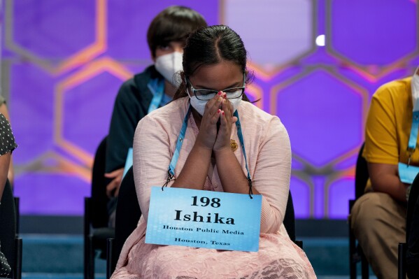 FILE - Ishika Varipilli, 11, from Spring, Texas, waits on stage during the Scripps National Spelling Bee, Wednesday, June 1, 2022, in Oxon Hill, Md. Since 1999, 28 of the last 34 Scripps National Spelling bee champions have been Indian American. The experiences of first-generation Indian Americans and their spelling bee champion children illustrate the economic success and cultural impact of the nation’s second-largest immigrant group. (AP Photo/Andrew Harnik, File)