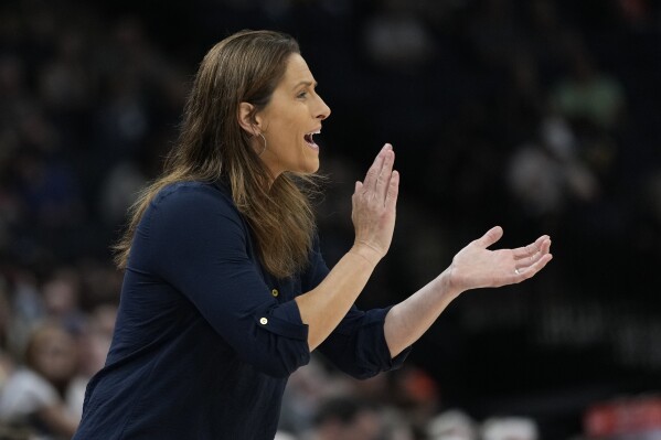 Connecticut Sun coach Stephanie White applauds during the first half of Game 3 of the team's WNBA first-round basketball playoff series against the Minnesota Lynx, Wednesday, Sept. 20, 2023, in Minneapolis. (AP Photo/Abbie Parr)