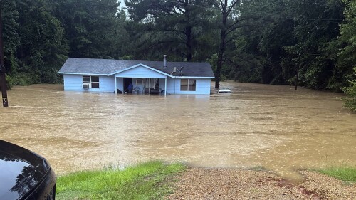 In this image provided by Mississippi state Rep. Michael Evans, floodwaters surround a home in Louisville, Miss., Thursday, July 13, 2023. Flash flooding was also reported Thursday in Winston, Choctaw, Neshoba and Noxubee counties. (Mississippi state Rep. Michael Evans via the AP)