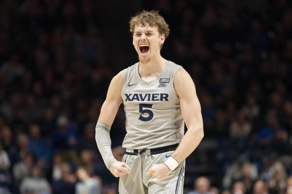 Xavier's Adam Kunkel (5) reacts after a Jerome Hunter (2) basket during the first half of an NCAA college basketball game against Providence, Wednesday, Feb. 1, 2023, in Cincinnati. (AP Photo/Jeff Dean)