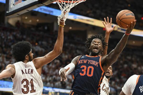 New York Knicks' Julius Randle (30) shoots against Cleveland Cavaliers' Jarrett Allen (31) during the second half of Game 1 in a first-round NBA basketball playoffs series Saturday, April 15, 2023, in Cleveland. (AP Photo/Nick Cammett)