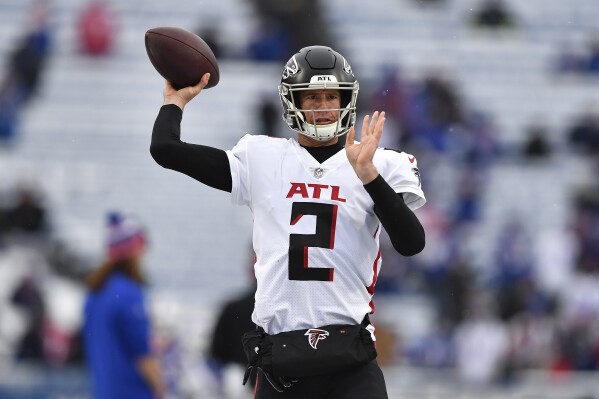 FILE -Atlanta Falcons quarterback Matt Ryan warms up before an NFL football game against the Buffalo Bills in Orchard Park, N.Y., Sunday, Jan. 2, 2022. Matt Ryan brought the No. 2 jersey back to the Atlanta Falcons training camp on Friday, Aug. 4, 2023.This time, however, the jerseys were worn by Ryan's 5-year-old twin boys, Johnny and Thomas. Ryan, the most accomplished quarterback in franchise history, returned as a sideline spectator, perhaps .(AP Photo/Adrian Kraus, File)