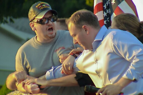 HOLD FOR STORY UPDATE - In this image taken from video provided by WHEC-TV, David Jakubonis, left, attacks U.S. Rep. Lee Zeldin, right, as he delivered a speech while campaigning for governor as New York's Republican candidate, in Perinton, N.Y., July 21, 2022. Jakubonis, who pleaded guilty in September to a misdemeanor charge of assaulting a federal officer, received three years of probation Thursday, Dec. 14, 2023. (WHEC-TV via AP)