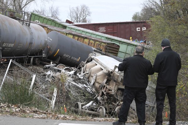 Director of Wayne County Homeland Security and Emergency Management Samer Jaafar, and an unidentified person, assess the situation at a train derailment at the intersection of Shook Road and Wick Road in Romulus, Michigan on Thursday, Nov. 2, 2023. (Daniel Mears/Detroit News via AP)