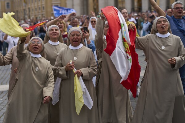Nuns cheer during Pope Leo XIV's appearance from the central balcony of St. Peter's Basilica for his first Sunday blessing after his election, in St. Peter's Square at the Vatican, Sunday, May 11, 2025.(AP Photo/Bernat Armangue)