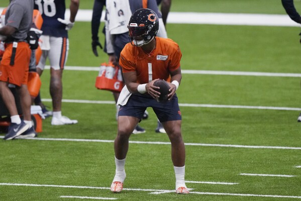 Chicago Bears quarterback Justin Fields looks to pass at the NFL football team's training camp in Lake Forest, Ill., Wednesday, July 26, 2023. (AP Photo/Nam Y. Huh)