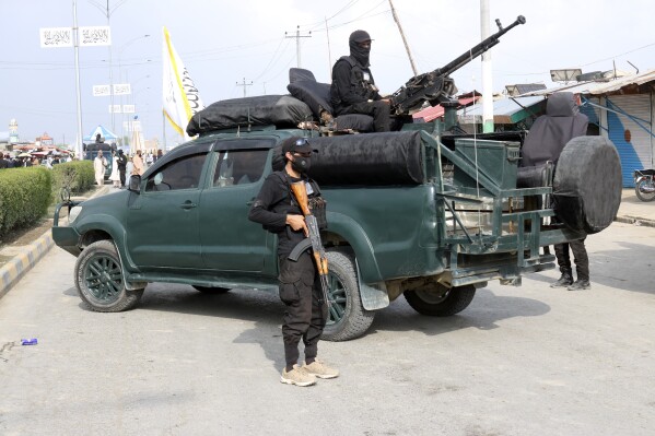 Taliban fighters stand guard in the site of explosion through a hotel in the city of Khost province eastern of Afghanistan, Monday, Aug. 14, 2023. An explosion ripped through the hotel in Afghanistan's eastern province, killing at least three people and wounding seven others, police said. (AP Photo/Saifullah Zahir)