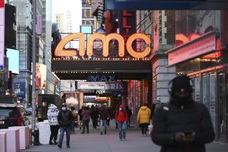The AMC Empire 25 theater reopens after COVID-19 closures, Friday, March 5, 2021, in New York. Movie theater chain AMC is selling 8.5 million shares to investment firm Mudrick Capital Management, raising $230.5 million and cashing in on the meme stock frenzy that has helped boost its stock price in recent months. AMC Entertainment Holdings Inc. said Tuesday, June 1 that it will use most of the proceeds for acquisitions of additional theater leases and to invest in its existing theaters to make them more attractive to moviegoers.   (Photo by Evan Agostini/Invision/AP)
