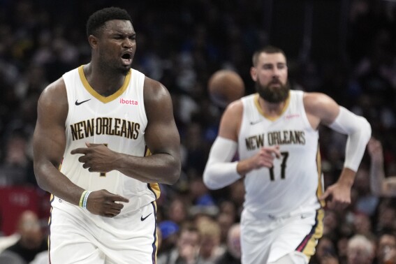 New Orleans Pelicans forward Zion Williamson, left, reacts after scoring during the first half of an NBA In-Season Tournament basketball game against the Los Angeles Clippers, Friday, Nov. 24, 2023, in Los Angeles. (AP Photo/Marcio Jose Sanchez)