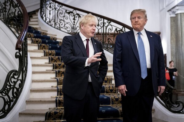 FILE - In this Aug. 25, 2019, file photo, President Donald Trump and Britain's Prime Minister Boris Johnson, left, speak to the media before a working breakfast meeting at the Hotel du Palais on the sidelines of the G-7 summit in Biarritz, France. Johnson says he’ll tell President Donald Trump that the U.K.’s state-funded health service will be off the table in any future trade negotiations, and that the U.S. will have to open its markets to British goods if it wants to make a deal. (Erin Schaff/The New York Times, Pool, File)