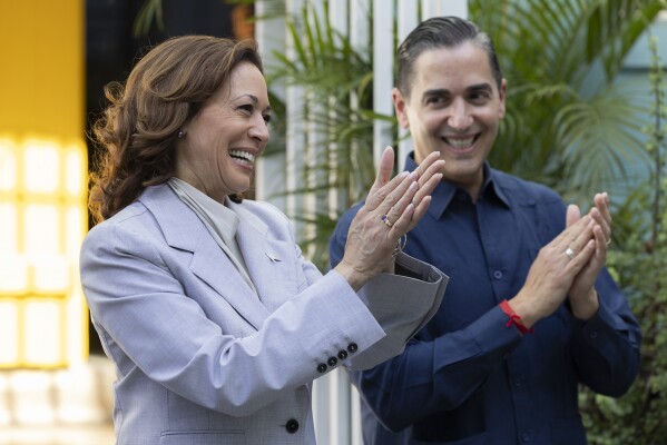 Vice President Kamala Harris, left, and Frankie Miranda, Hispanic Federation president, applaud, during a visit, in San Juan, Puerto Rico, Friday, March 22, 2024. Harris visited Puerto Rico on Friday as part of a whirlwind trip to tout the federal aid the U.S. territory has received following deadly hurricanes and attend a Democratic fundraiser. (AP Photo/Alejandro Granadillo)