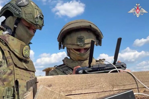 In this photo taken from video distributed by the Russian Defense Ministry Press Service on Monday, May 26, 2025, Russian serviceman train to operate military drones in an undisclosed location. (Russian Defense Ministry Press Service via AP)