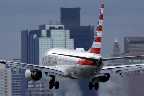 FILE - An American Airlines plane lands at Logan International Airport, Thursday, Jan. 26, 2023, in Boston. American Airlines said Thursday, Aug. 17, 2023, that it will start flying to three new destinations in Europe next summer — Copenhagen, Naples and Nice, France. (AP Photo/Michael Dwyer, File)