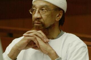 FILE- In this March 11, 2002 file photo, Jamil Abdullah Al-Amin watches during the sentencing portion of his trial in Atlanta.  A federal appeals court has rejected an attempt by the 1960s black militant formerly known as H. Rap Brown to challenge his imprisonment for the killing of a sheriff's deputy. The 11th U.S. Circuit Court of Appeals ruled Wednesday, July 31, 2019 in the case of the man now known as Jamil Abdullah Al-Amin. He was convicted in 2002 of killing Fulton County sheriff's deputy Ricky Kinchen and wounding Kinchen’s partner, Deputy Aldranon English.  (AP Photo/Ric Feld, File)