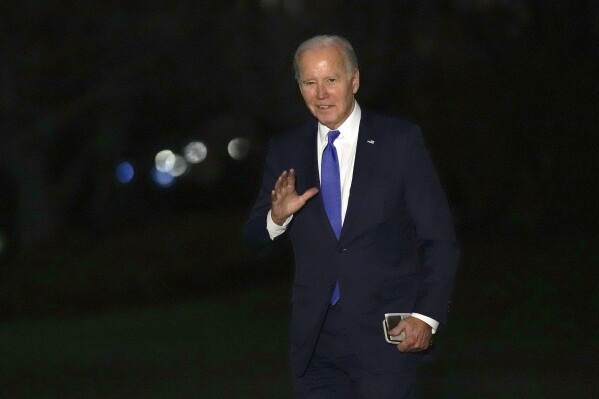 President Joe Biden waves as he walks across the South Lawn of the White House in Washington, Wednesday, Feb. 7, 2024, after returning from New York where he attended three fundraisers. (APPhoto/Susan Walsh)