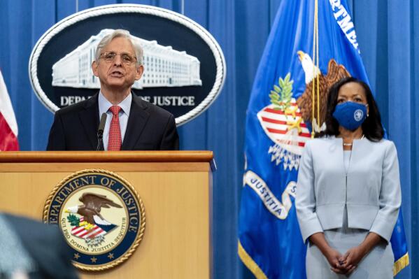 Attorney General Merrick Garland, accompanied by Assistant Attorney General for Civil Rights Kristen Clarke, right, speaks at a news conference at the Department of Justice in Washington, Thursday, Aug. 5, 2021, to announce that the Department of Justice is opening an investigation into the city of Phoenix and the Phoenix Police Department. (AP Photo/Andrew Harnik)