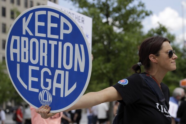 FILE - An abortion-rights demonstrator holds a sign during a rally, May 14, 2022, in Chattanooga, Tenn. On Wednesday, April 10, 2024, Republican lawmakers in Tennessee advanced legislation making it illegal for adults to help minors get an abortion without parental consent. (AP Photo/Ben Margot, File)